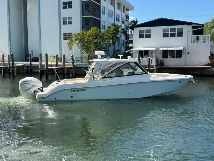  Yacht Photos Pics 2019 Everglades 340 Dual Console boat on water near residential buildings.