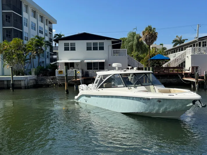  Yacht Photos Pics 2019 Everglades 340 Dual Console boat on water near residential buildings.