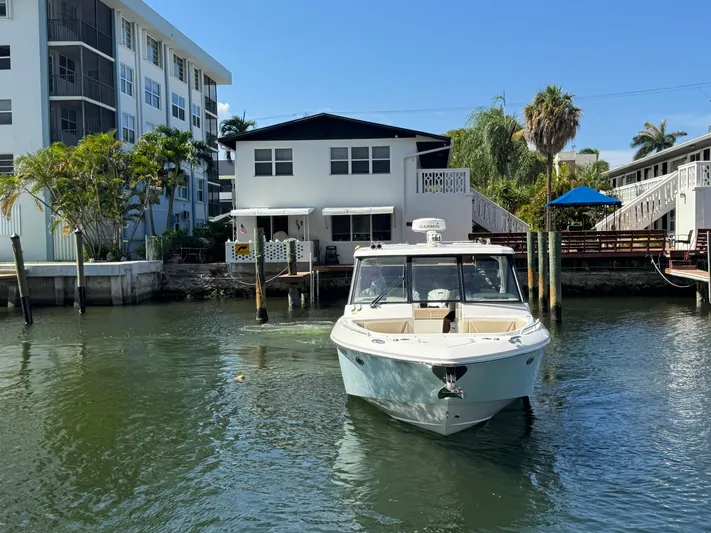  Yacht Photos Pics 2019 Everglades 340 Dual Console boat docked near waterfront home.