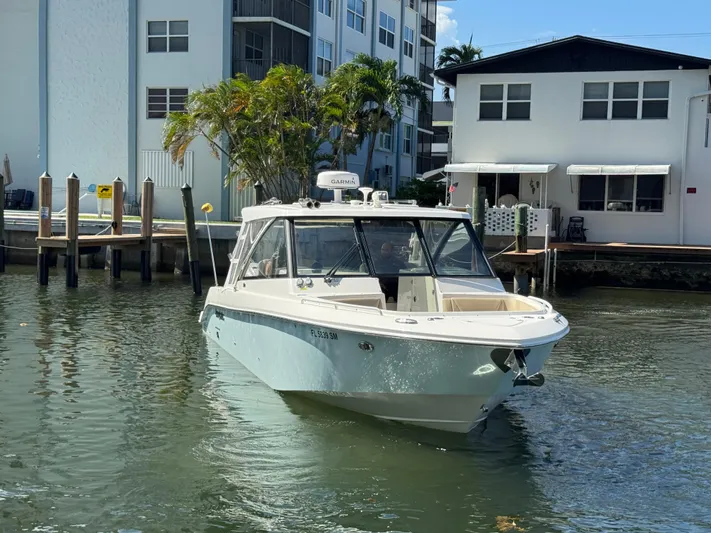  Yacht Photos Pics 2019 Everglades 340 Dual Console boat docked near waterfront homes.