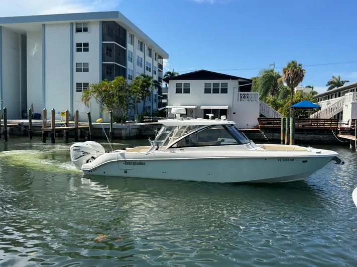  Yacht Photos Pics 2019 Everglades 340 Dual Console boat docked near waterfront buildings.