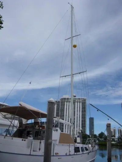 Maraya Yacht Photos Pics 1990 Cheoy Lee Sloop docked with city skyline in background.