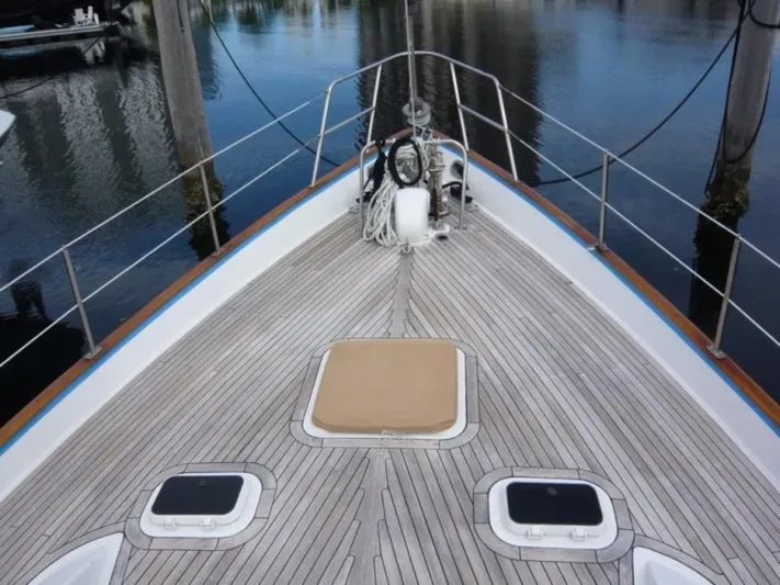 Maraya Yacht Photos Pics Deck of 1990 Cheoy Lee Sloop with wooden finish and hatches, docked at marina.