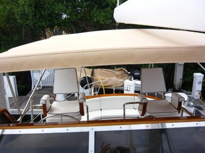 Maraya Yacht Photos Pics 1990 Cheoy Lee Sloop with covered seating area and white cushioned chairs.