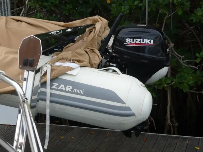 Maraya Yacht Photos Pics Inflatable Zar Mini boat with Suzuki outboard motor, docked near a Cheoy Lee Sloop, 1990 model.