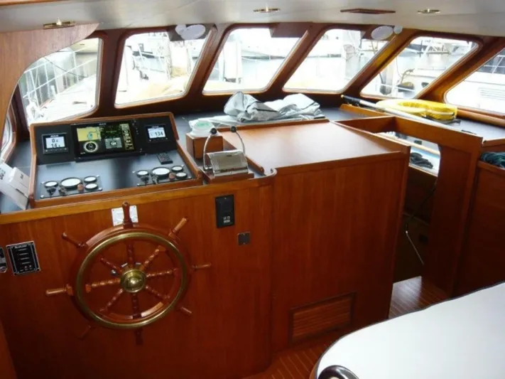 Maraya Yacht Photos Pics 1990 Cheoy Lee Sloop interior with wooden helm and navigation instruments.