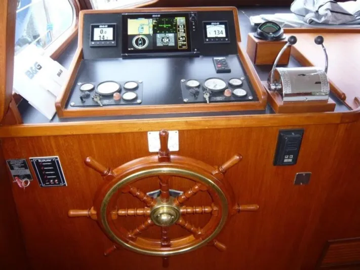 Maraya Yacht Photos Pics 1990 Cheoy Lee Sloop helm with navigation instruments and wooden steering wheel.