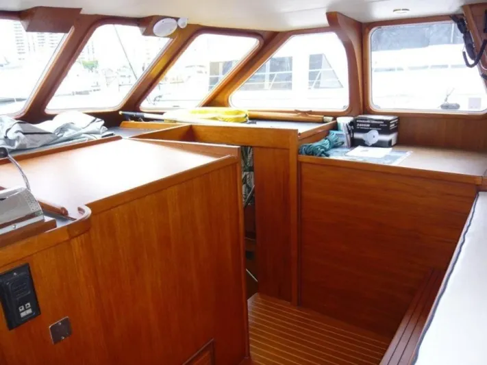 Maraya Yacht Photos Pics Interior of 1990 Cheoy Lee Sloop with wooden finish and large windows.