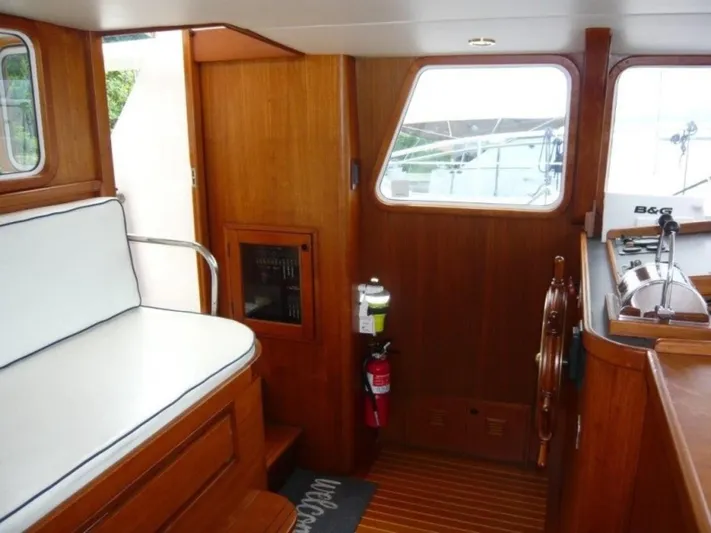 Maraya Yacht Photos Pics Interior of 1990 Cheoy Lee Sloop with wooden finish and nautical equipment.