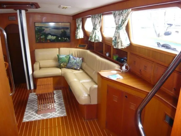 Maraya Yacht Photos Pics Interior of 1990 Cheoy Lee Sloop with cozy seating and wooden decor.