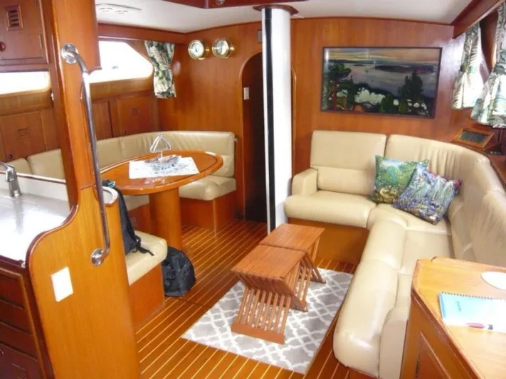 Maraya Yacht Photos Pics Luxurious 1990 Cheoy Lee Sloop interior with wood finish, cozy seating, and nautical decor.