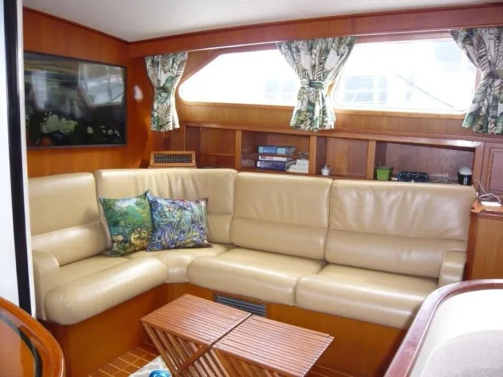 Maraya Yacht Photos Pics Interior of 1990 Cheoy Lee Sloop with beige leather seating and wooden accents.