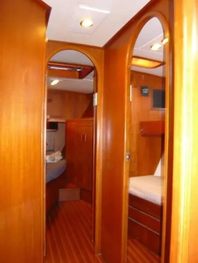 Maraya Yacht Photos Pics Interior of 1990 Cheoy Lee Sloop, featuring wooden paneling and cozy cabin spaces.