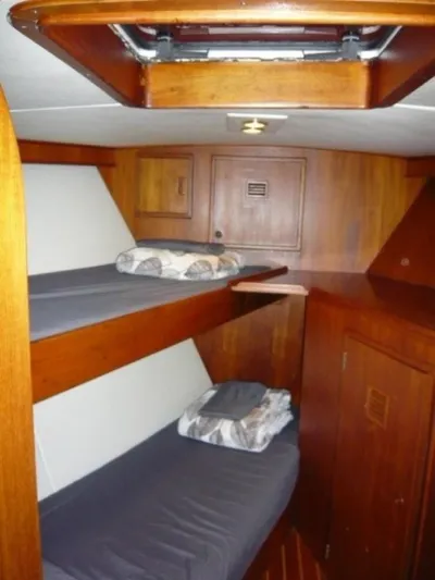 Maraya Yacht Photos Pics 1990 Cheoy Lee Sloop interior with wooden bunk beds and storage cabinets.