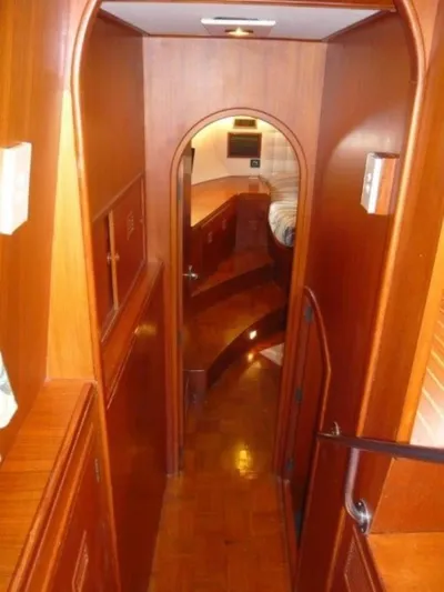 Maraya Yacht Photos Pics Interior of 1990 Cheoy Lee Sloop, featuring wooden paneling and cozy cabin design.