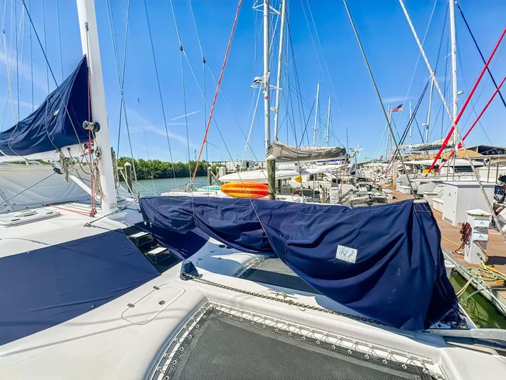 Kisa Yacht Photos Pics Sailboats docked at marina, featuring a 2000 Manta 42 catamaran under clear blue skies.