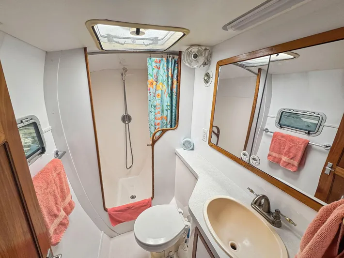 Kisa Yacht Photos Pics Bathroom interior of 2000 Manta 42 yacht with shower, sink, and mirror.