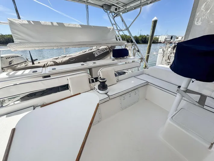 Kisa Yacht Photos Pics 2000 Manta 42 sailboat cockpit with seating, winch, and marina view.