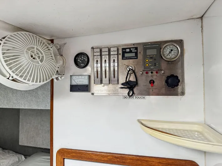 Kisa Yacht Photos Pics Control panel inside a 2000 Manta 42 boat cabin with fan and gauges.