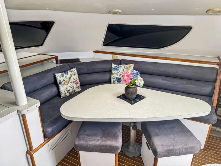 Kisa Yacht Photos Pics Cozy dining area in a 2000 Manta 42 yacht with floral decor and cushioned seating.