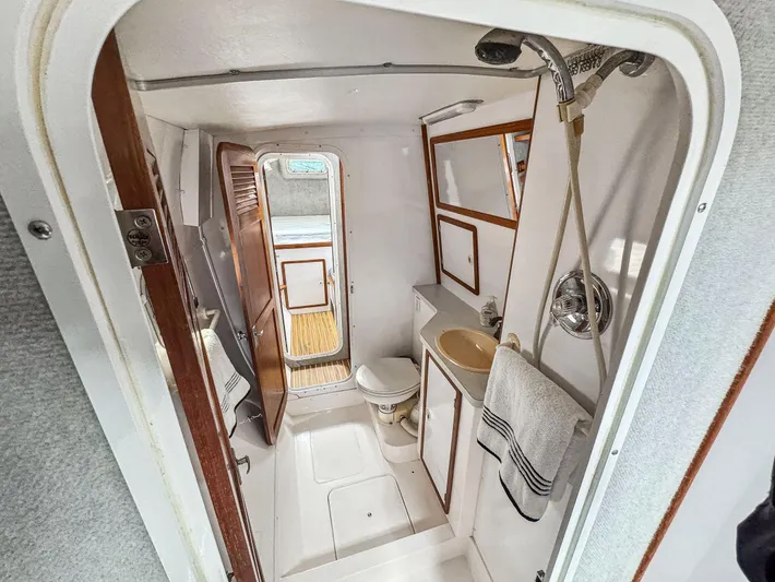 Kisa Yacht Photos Pics Bathroom interior of 2000 Manta 42 yacht, featuring shower, sink, and toilet.