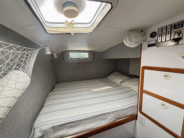 Kisa Yacht Photos Pics Cozy cabin interior of 2000 Manta 42 sailboat with bed and storage.