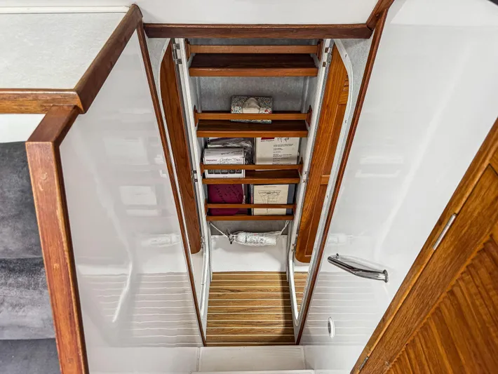 Kisa Yacht Photos Pics Interior view of 2000 Manta 42 sailboat with wooden shelves and storage.