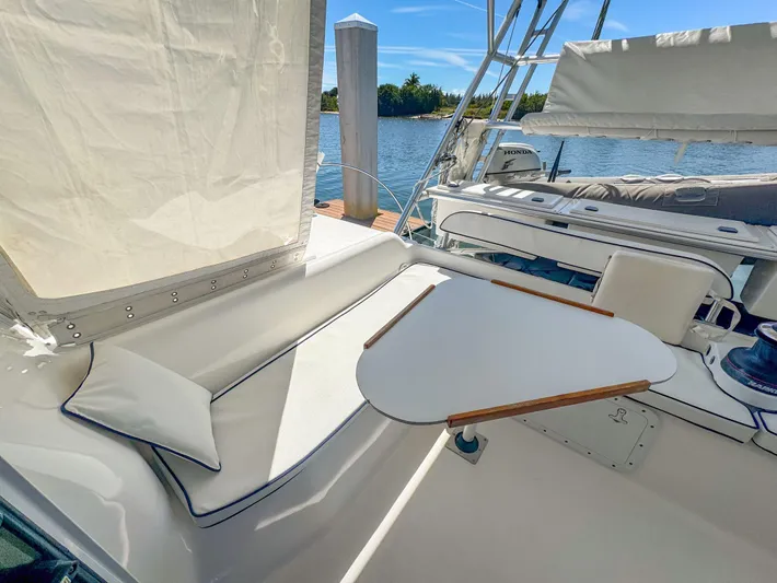 Kisa Yacht Photos Pics Manta 42 yacht cockpit with seating and table, docked by the water, 2000 model.