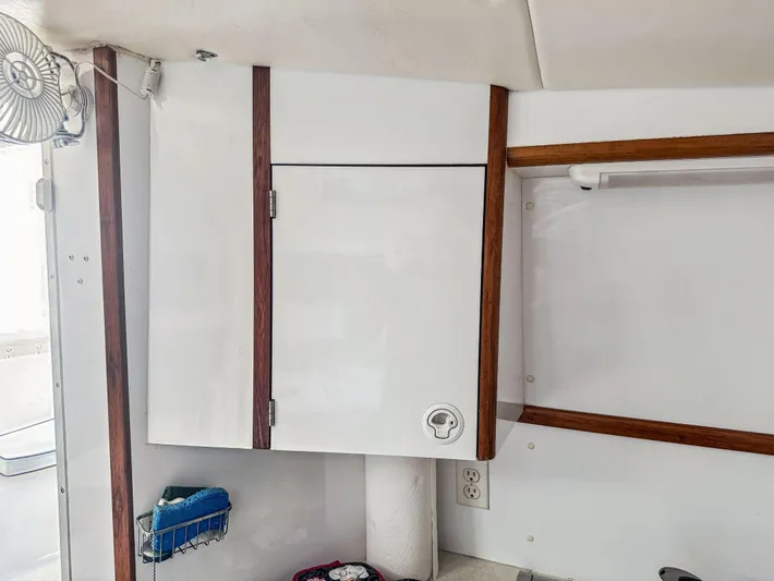 Kisa Yacht Photos Pics Interior of a 2000 Manta 42 boat showing a white cabinet with wooden trim.