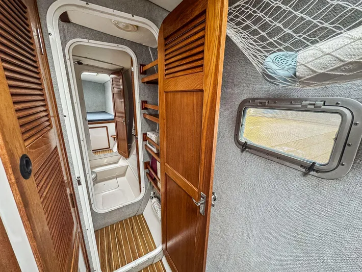 Kisa Yacht Photos Pics Interior of 2000 Manta 42 sailboat with wooden doors and compact cabin space.