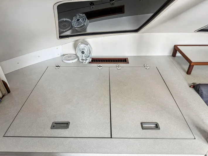 Kisa Yacht Photos Pics Interior of a 2000 Manta 42 catamaran with storage compartments and a mirror.