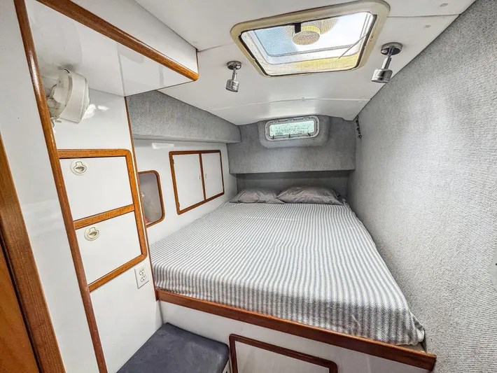 Kisa Yacht Photos Pics Cozy cabin interior of 2000 Manta 42 sailboat with bed and storage.