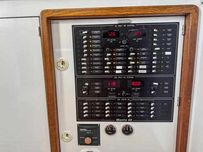 Kisa Yacht Photos Pics Electrical panel of a 2000 Manta 42 boat with wooden frame.