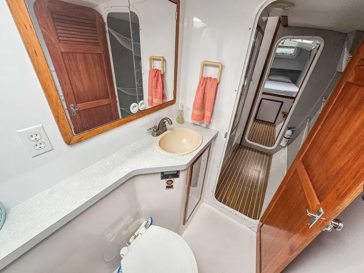 Kisa Yacht Photos Pics Bathroom interior of 2000 Manta 42 yacht with sink, mirror, and wooden accents.