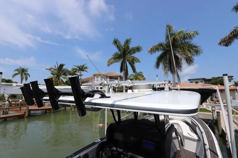  Yacht Photos Pics 2019 Statement 350 Open boat docked near palm trees and waterfront homes.