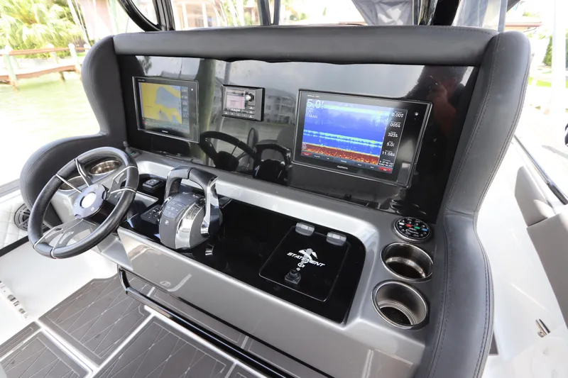  Yacht Photos Pics Control panel of a 2019 Statement 350 Open boat with navigation screens and steering wheel.
