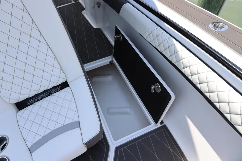  Yacht Photos Pics 2019 Statement 350 Open boat interior with white quilted seats and storage compartment.