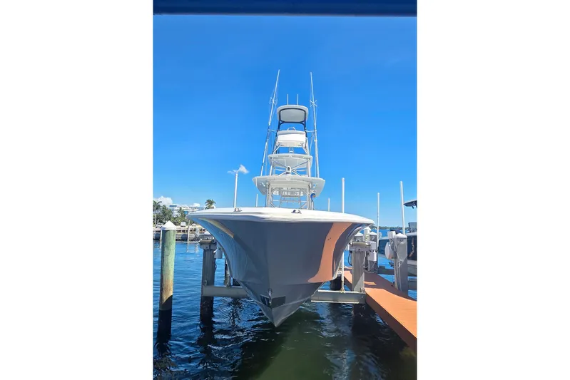 Hat Trick Yacht Photos Pics 2020 SeaVee 390Z boat docked at marina under clear blue sky.