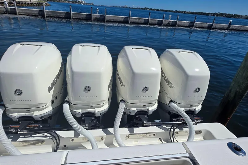 Hat Trick Yacht Photos Pics Four Mercury outboard engines on a 2020 SeaVee 390Z boat, docked by the water.