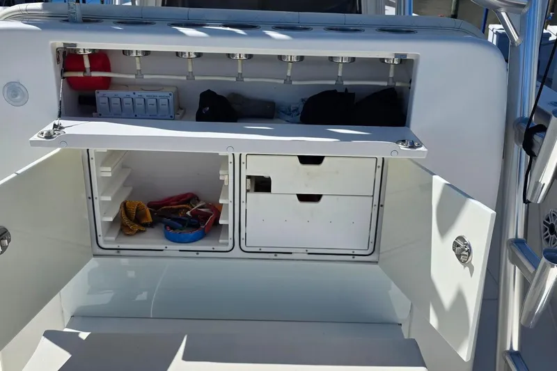 Hat Trick Yacht Photos Pics 2020 SeaVee 390Z boat storage compartments with open doors, showcasing organized interior space.