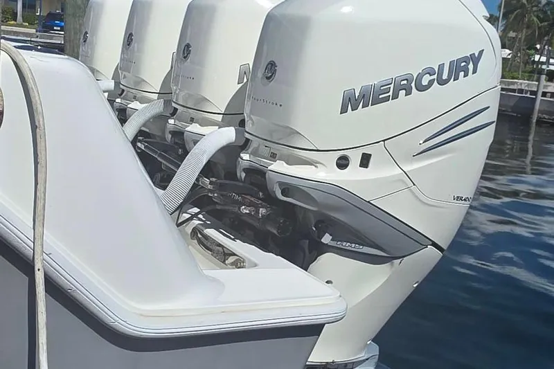 Hat Trick Yacht Photos Pics 2020 SeaVee 390Z boat with multiple Mercury outboard engines docked on water.
