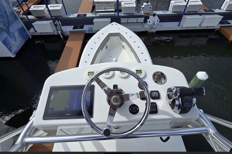 Hat Trick Yacht Photos Pics 2020 SeaVee 390Z boat helm with steering wheel and navigation controls at dock.