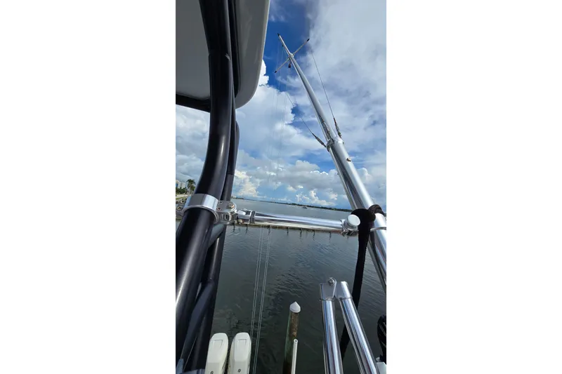 Hat Trick Yacht Photos Pics 2020 SeaVee 390Z boat with fishing rods against a cloudy sky backdrop.