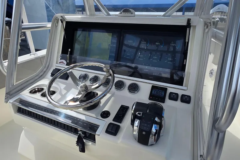 Hat Trick Yacht Photos Pics 2020 SeaVee 390Z boat dashboard with steering wheel and digital display.
