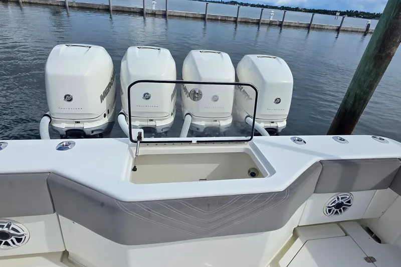 Hat Trick Yacht Photos Pics 2020 SeaVee 390Z boat with four Mercury outboard engines docked by the water.