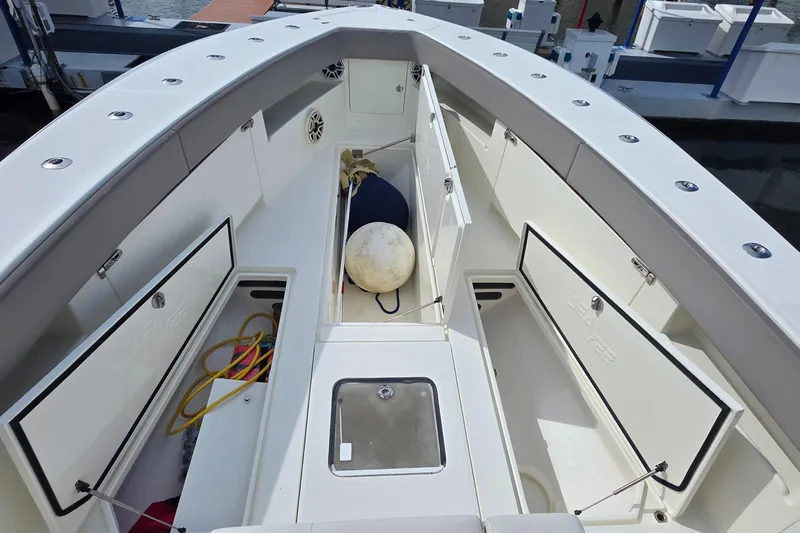Hat Trick Yacht Photos Pics 2020 SeaVee 390Z boat deck with open storage compartments and marine equipment.
