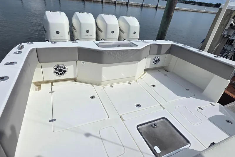Hat Trick Yacht Photos Pics 2020 SeaVee 390Z boat deck with quad Mercury engines, spacious seating, and storage compartments.