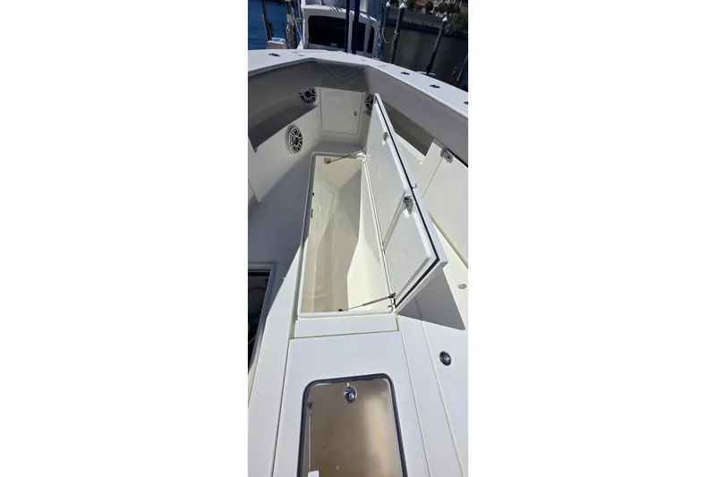 Hat Trick Yacht Photos Pics 2020 SeaVee 390Z boat with open storage compartment, showcasing sleek design.