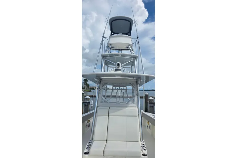 Hat Trick Yacht Photos Pics 2020 SeaVee 390Z boat with tower, docked under a cloudy sky.