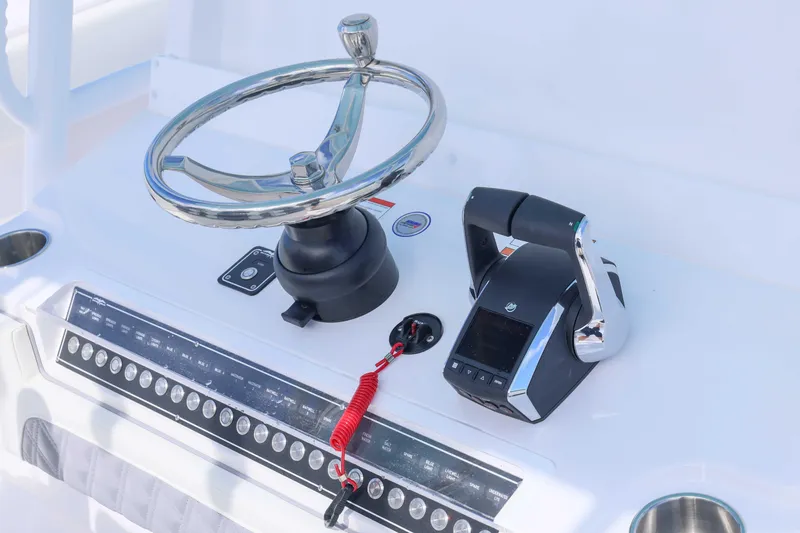  Yacht Photos Pics Steering console of 2025 Invincible 35 Catamaran with modern controls and chrome wheel.